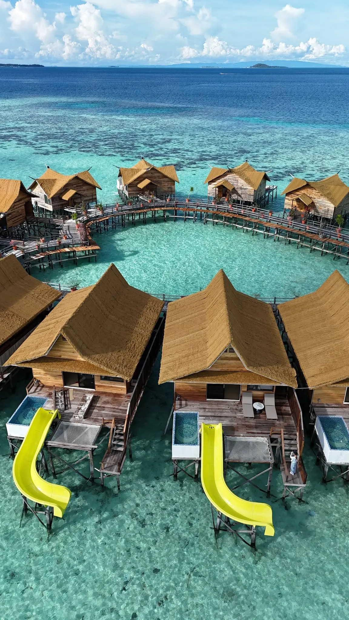 Aerial view of Cupid Water Bungalow overwater villas with private pools and yellow water slides