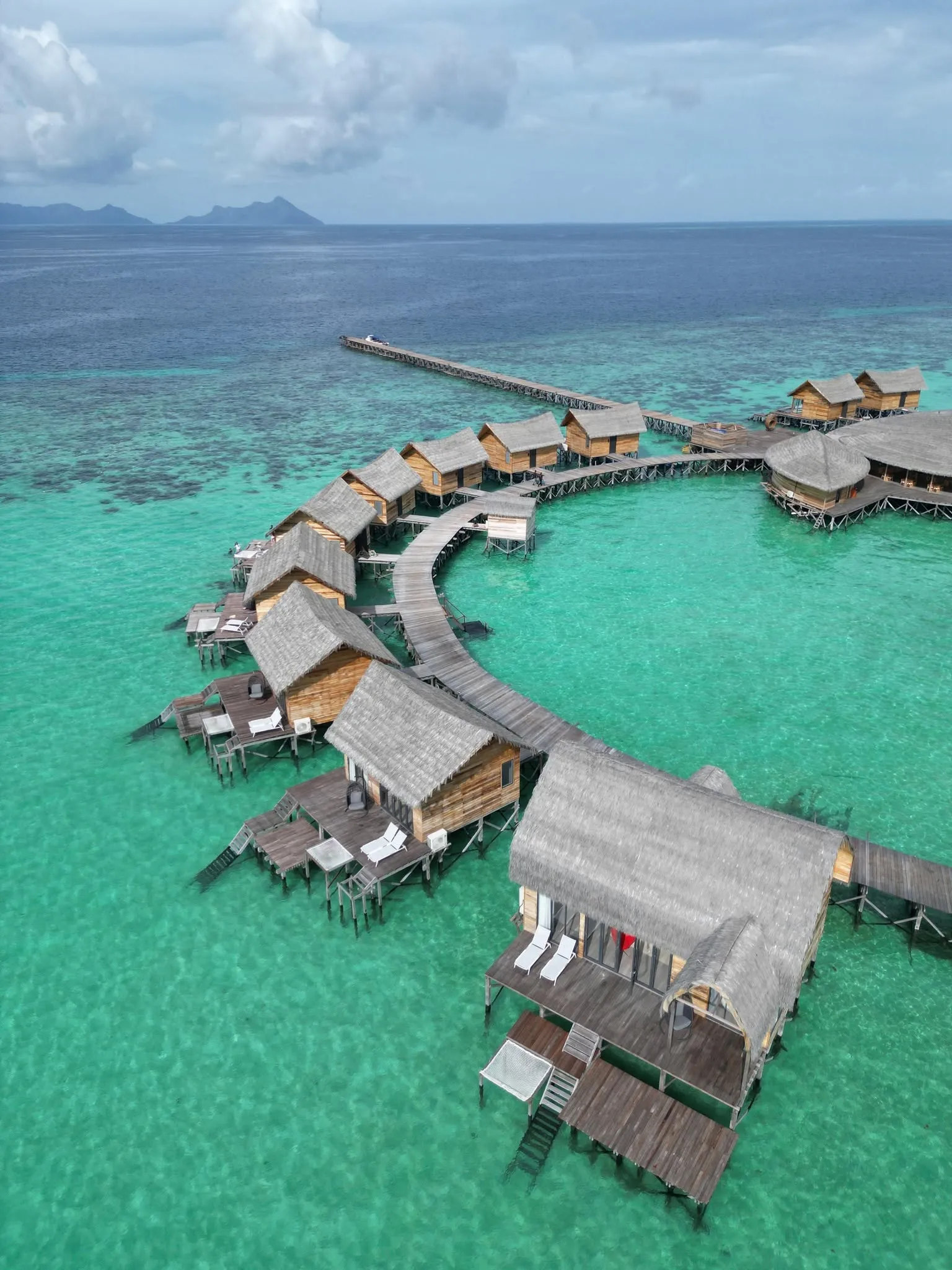 Curved boardwalk linking Cupid Water Bungalow overwater villas